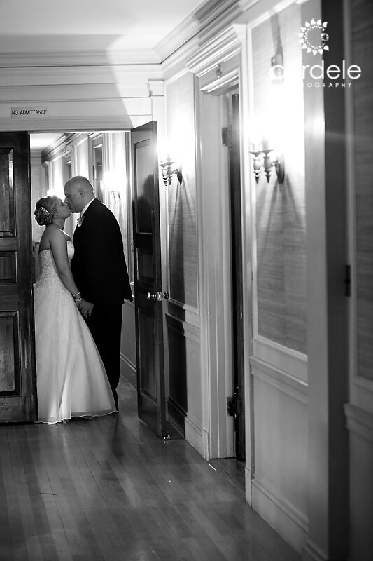 A black and white photo of a bride and groom kissing at the endicott estate in Dedham